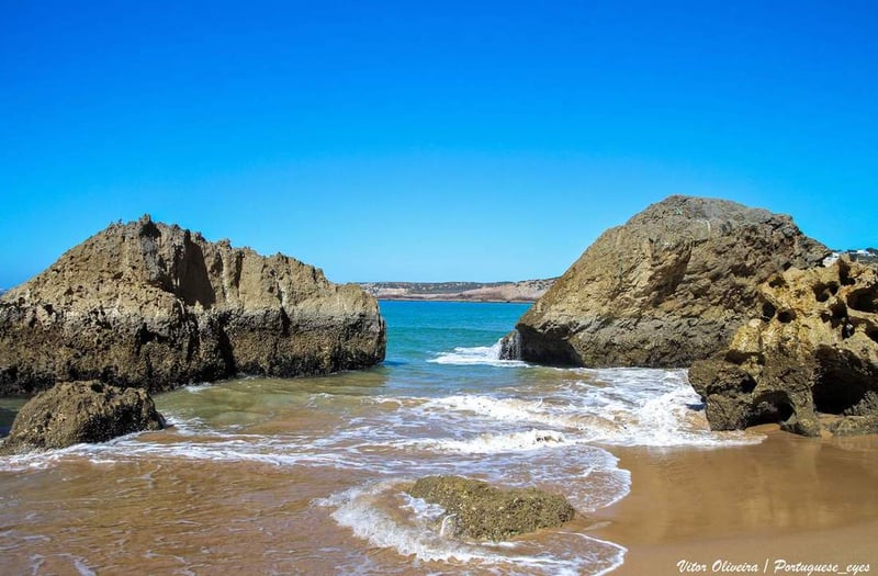 Rock formations framing the bay at Praia do Zavial