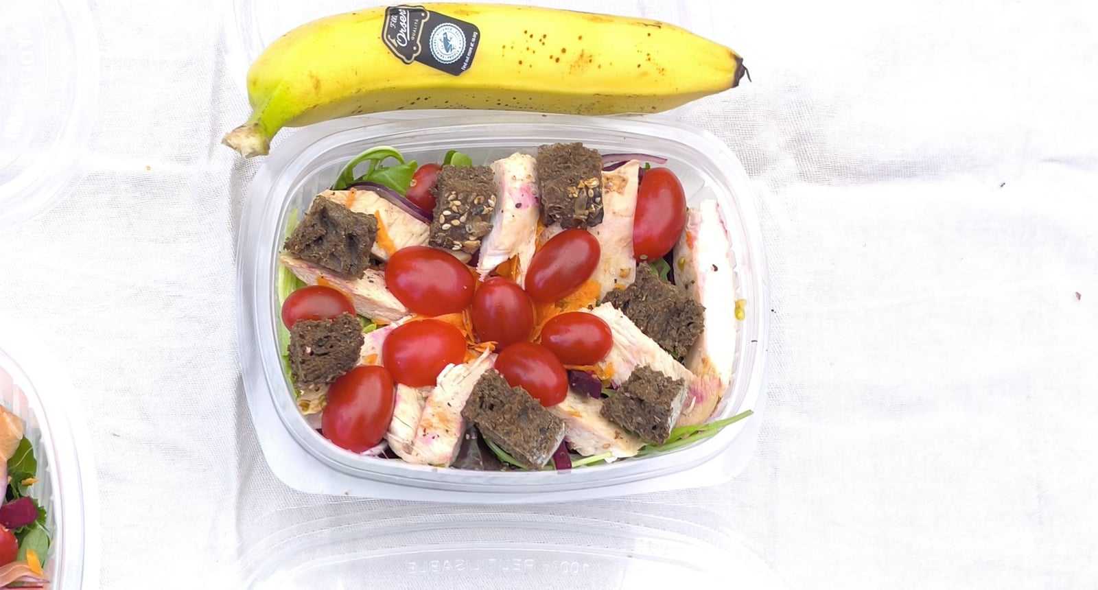 Traking Transfers Chicken Salad Pack: grilled chicken salad with cherry tomatoes and seeded-bread croutons, topped with a banana