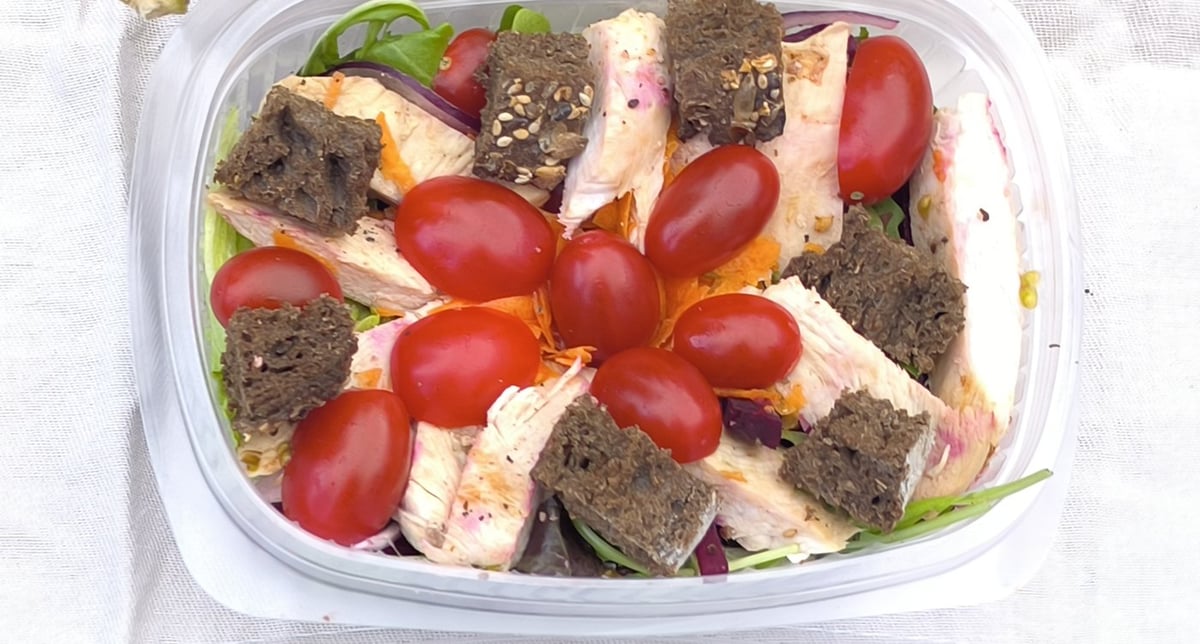Traking Transfers Chicken Salad: grilled chicken breast, cherry tomatoes, grated carrot and seeded-bread croutons on mixed greens